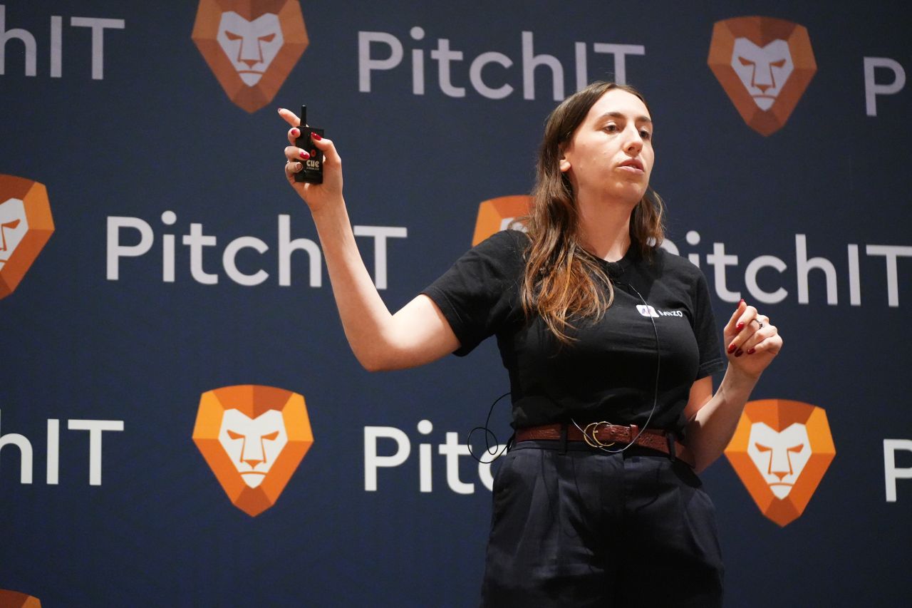 PitchIT presenter holding clicker on stage