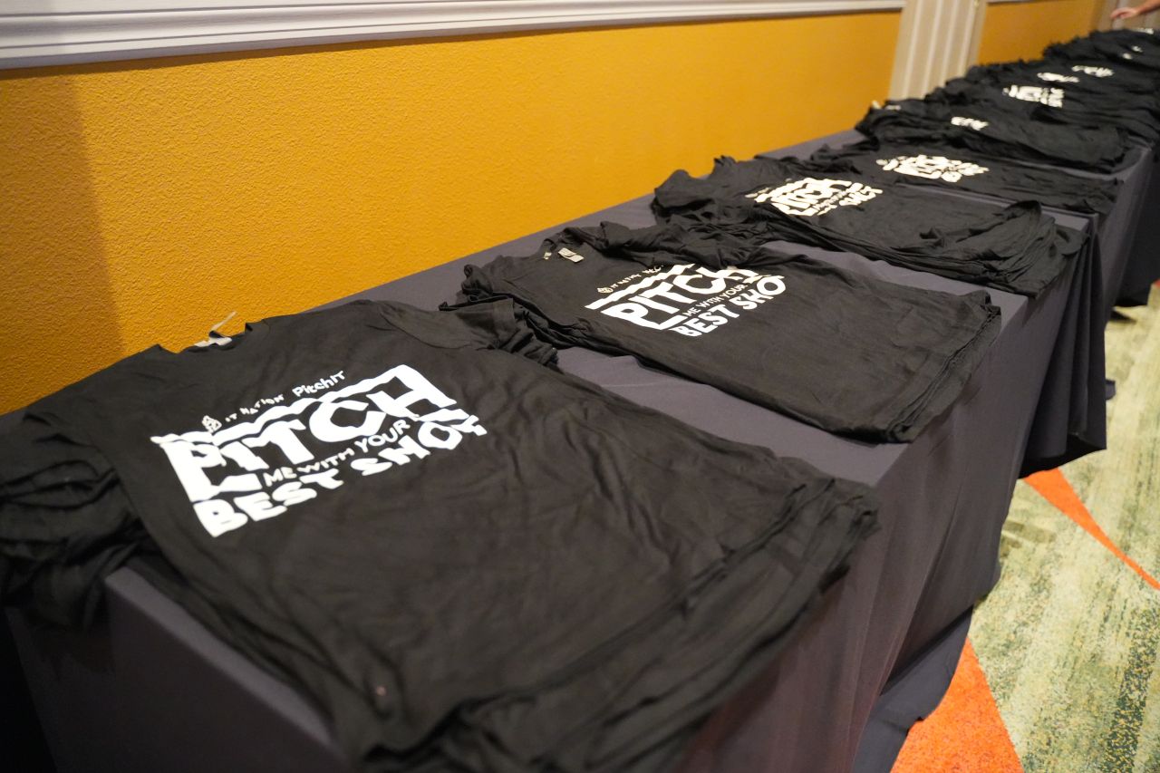 PitchIT branded t-shirts on table
